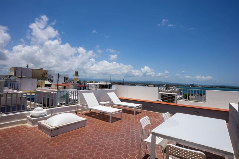 Bask in rooftop sun, surveying San Juan`s city and sea.