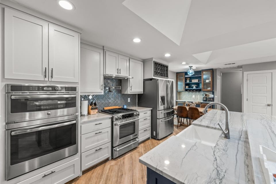 A chefs dream! This kitchen has 2 ovens, a 3 drawer fridge/freezer, filtered water attached,  and a show stopping island! Coffee station, pot filling faucet above the stove.