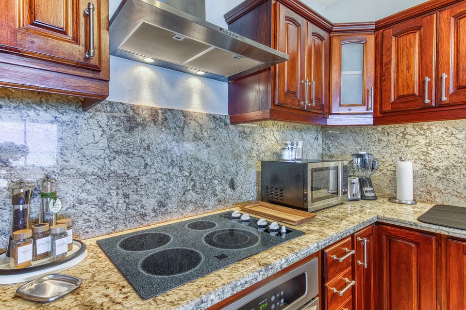 Granite counters and backslpash throughout kitchen area