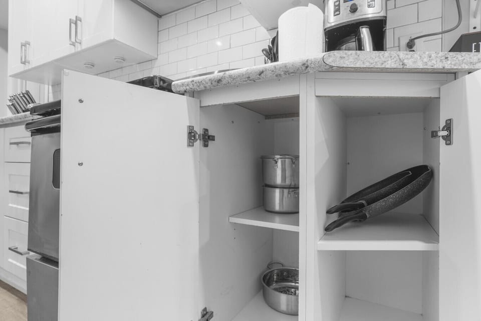 Prepare a home cooked meal with ease. Our kitchen is fully equipped with a variety of stainless steel pots and pans, neatly organized in clean cabinets to provide you with all the essentials for a perfect culinary stay.