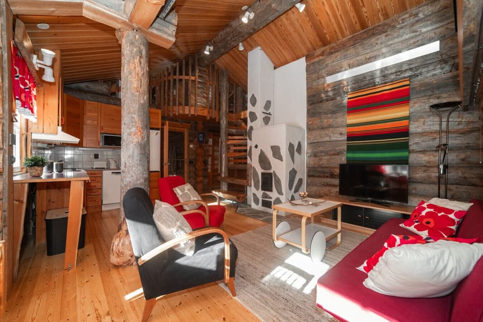 Relax in the comfy seating area by the fireplace, ideal for unwinding after a day exploring Ruka’s outdoors.