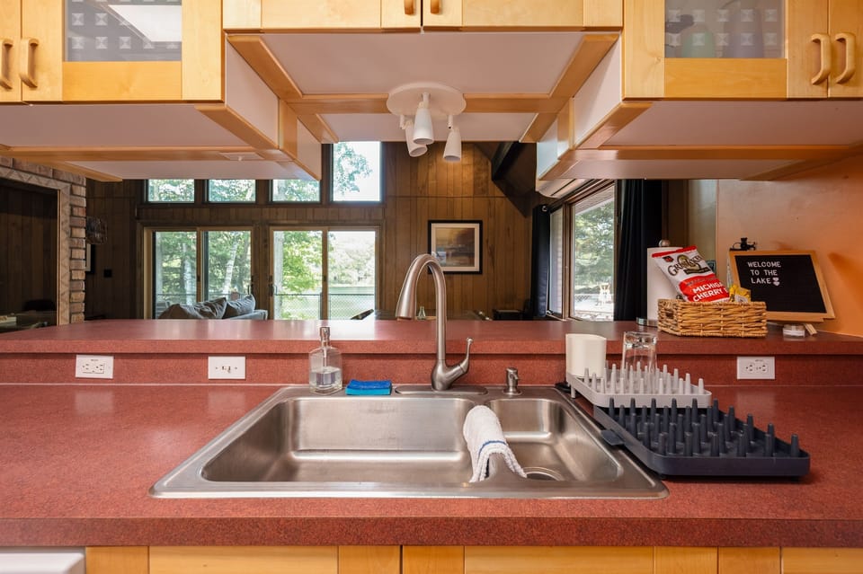 Kitchen sink view looking into the open living and dining space