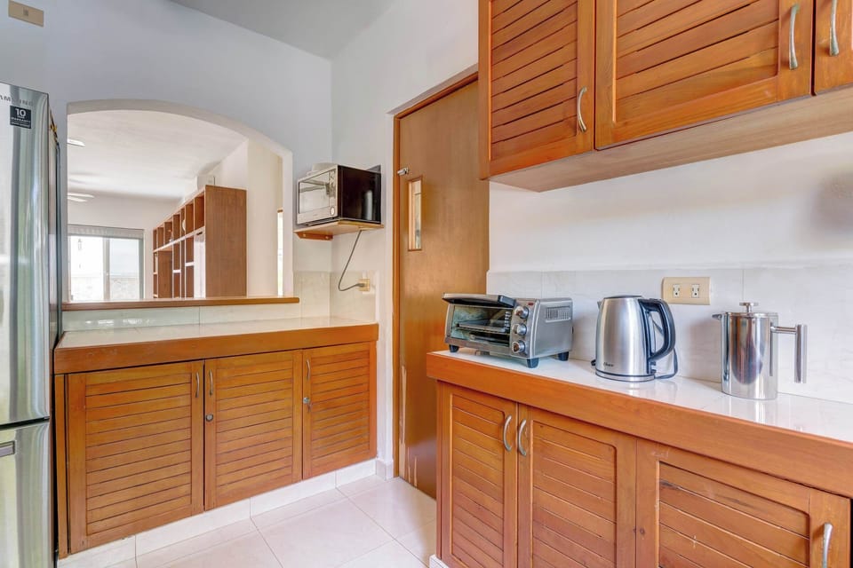 Whip up delicious meals in the fully equipped kitchen, featuring ample cabinet space.