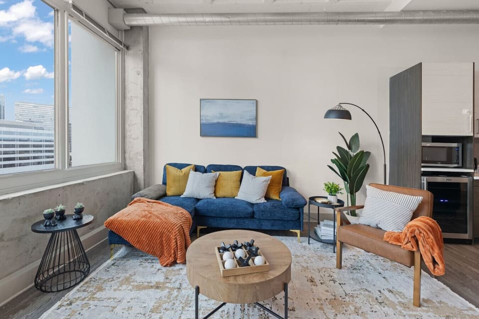 Stylish space with vibrant hues, city views, and inviting spots for fun gatherings!
