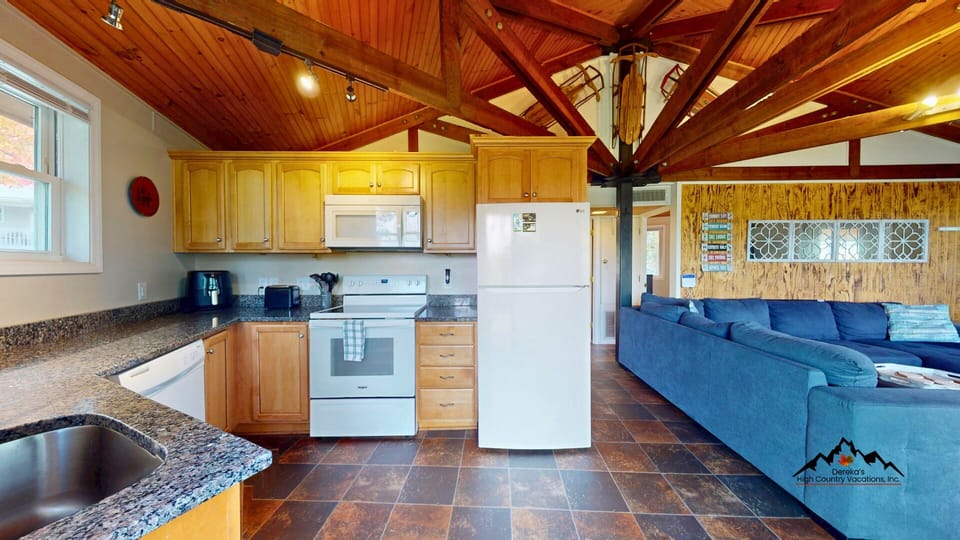 Fully stocked kitchen with modern appliances makes meals easy during your mountain getaway.