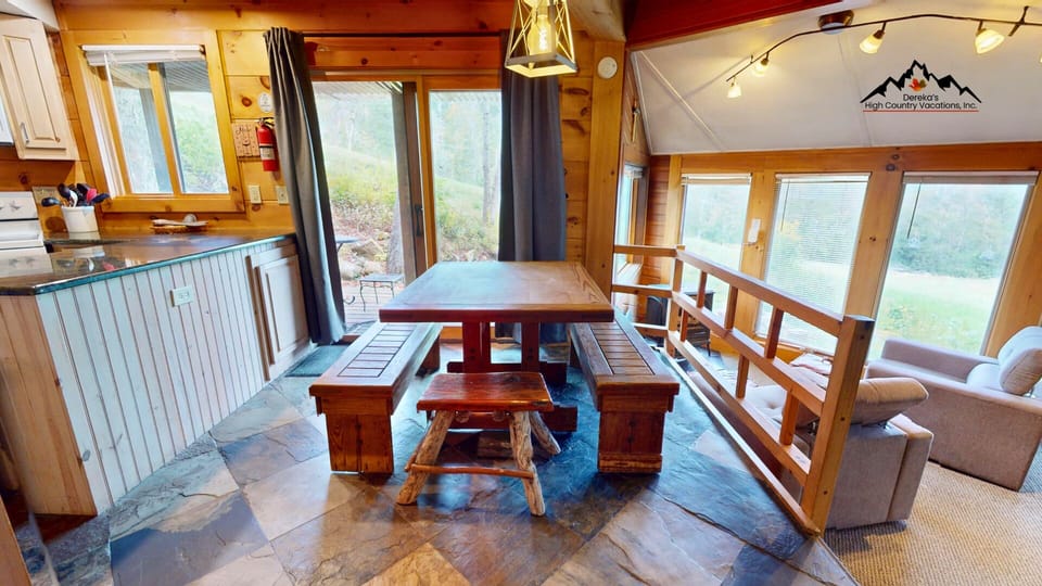 Gather around the large dining table with bench seating for meals, games, and conversations together.