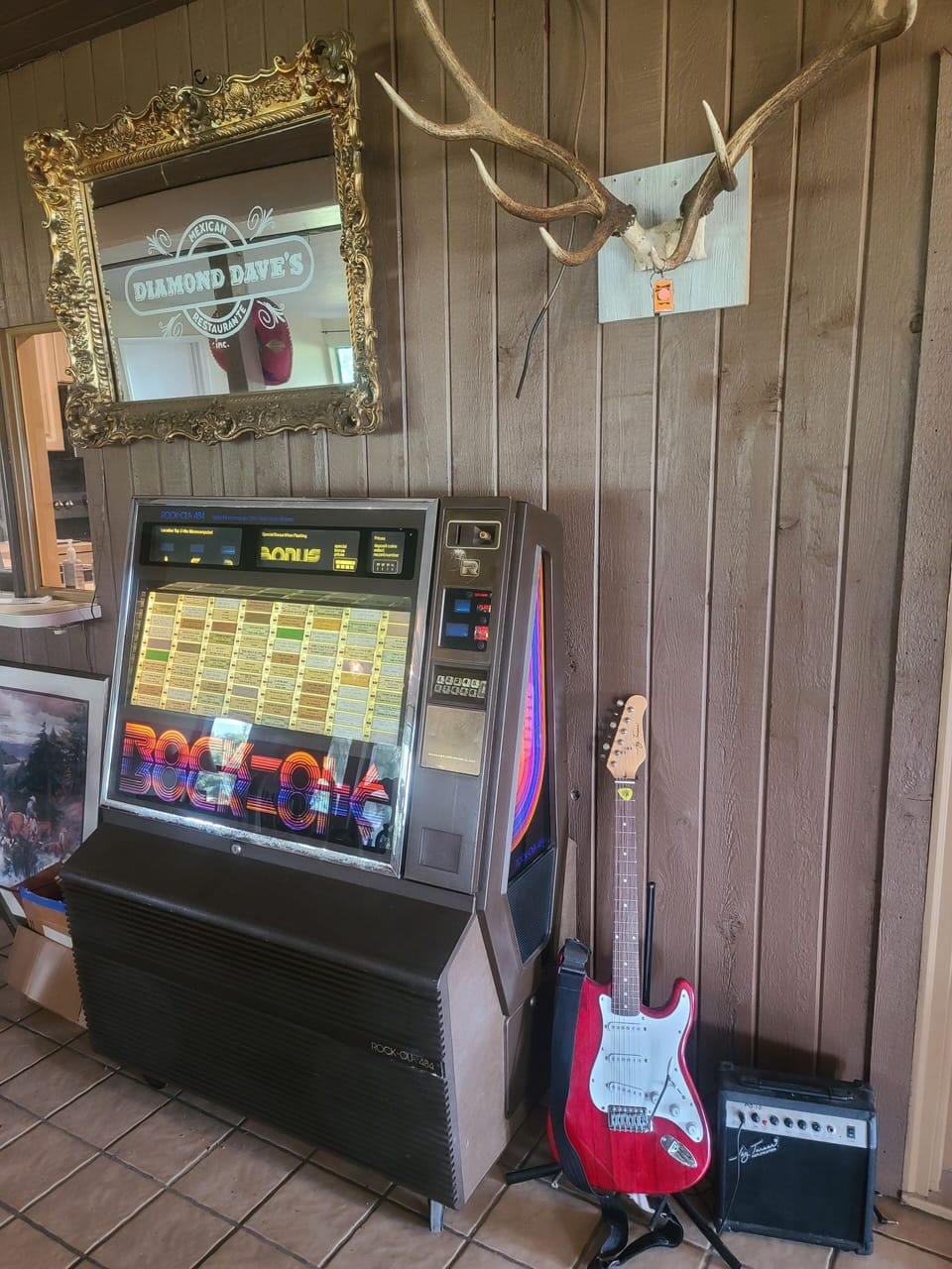 juke box, now on tilt, elk horns in game room