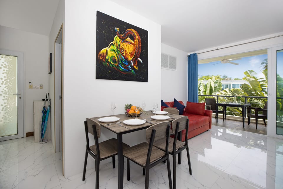 Dining area and living room with access to balcony