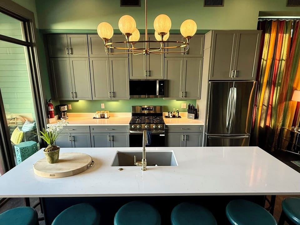 Kitchen area features a large island with state-of-the-art appliances.