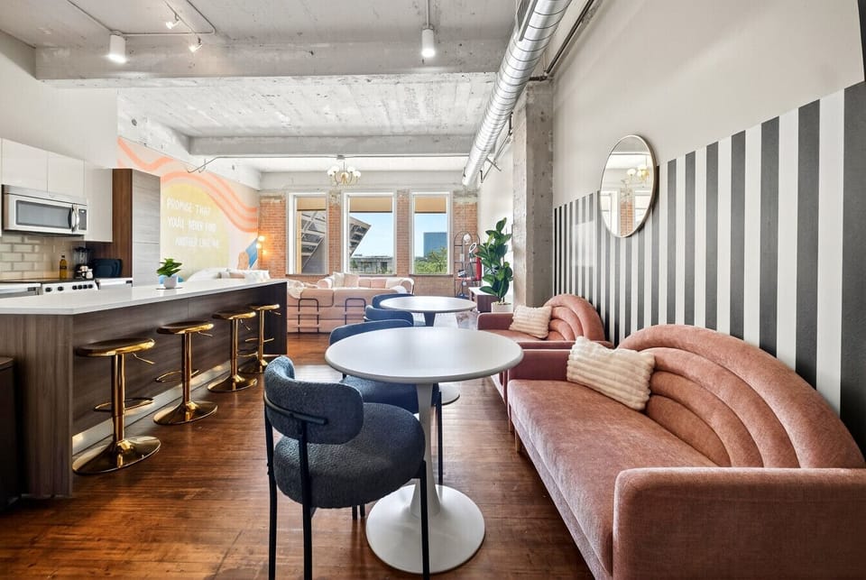 Sunlit & Spacious – exposed brick, high ceilings, and city views create your own urban “Enchanted” backdrop.