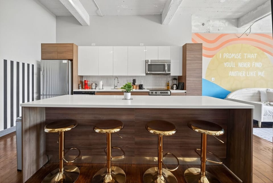 “Style” meets function – gold barstools, bold stripes, and sleek finishes make every meal feel like a statement.
