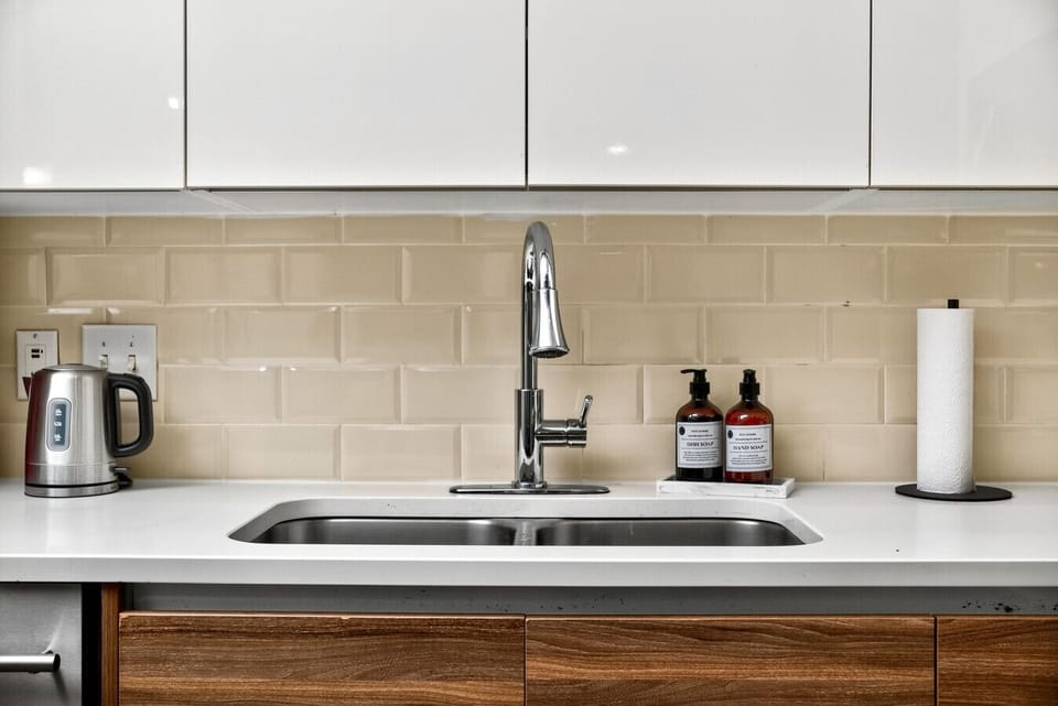 Retro Pit Stop: A sleek kitchen with all the gear you need—stainless steel appliances, modern backsplash, and road-trip essentials stocked. 🛠️