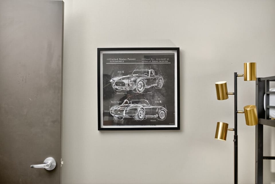 Automotive blueprint artwork celebrates retro car culture throughout the apartment.