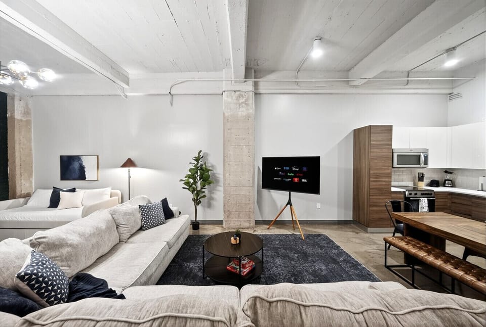 “Relax together” — Stretch out on the spacious sectional, stream your favorite shows, and enjoy the loft’s bright, open vibe