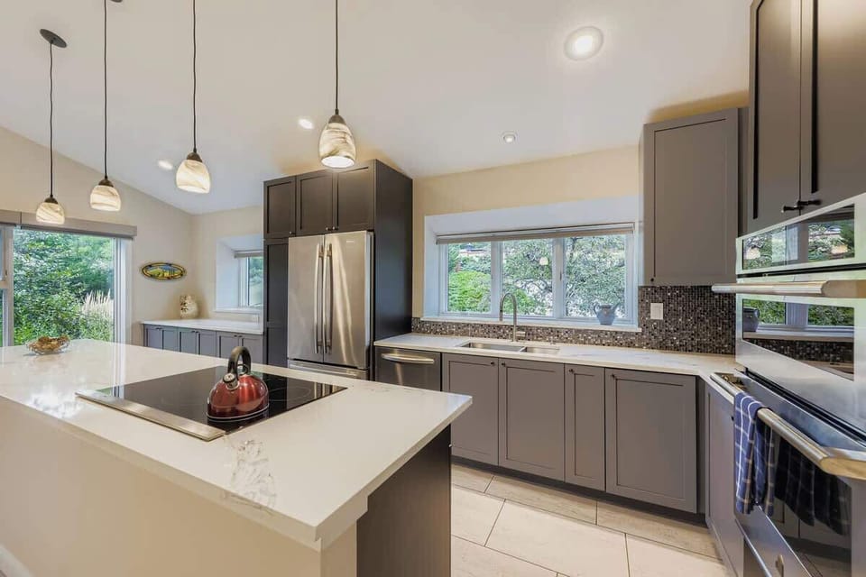 Bright, functional kitchen with a spacious island—perfect for cooking, serving meals, or gathering with friends and family.