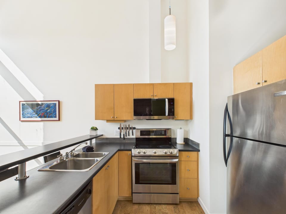 Everyday meals feel just a little more gourmet in this contemporary kitchen, equipped with ample cabinetry and stainless steel appliances.