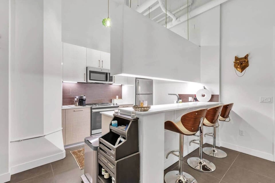 Charming kitchen with quality appliances, ample counter space, and warm lighting.