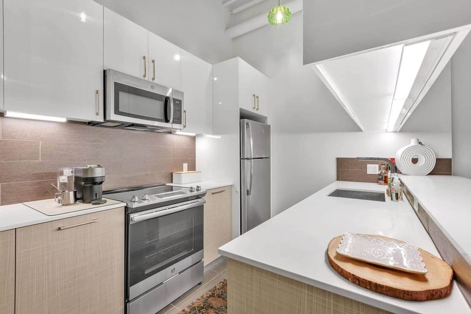 Well-equipped kitchen with stainless steel appliances, ample storage, and a smart layout.