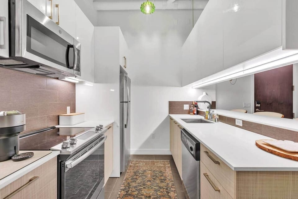 Stylish kitchen with sleek appliances, durable counters, and spacious cabinets.