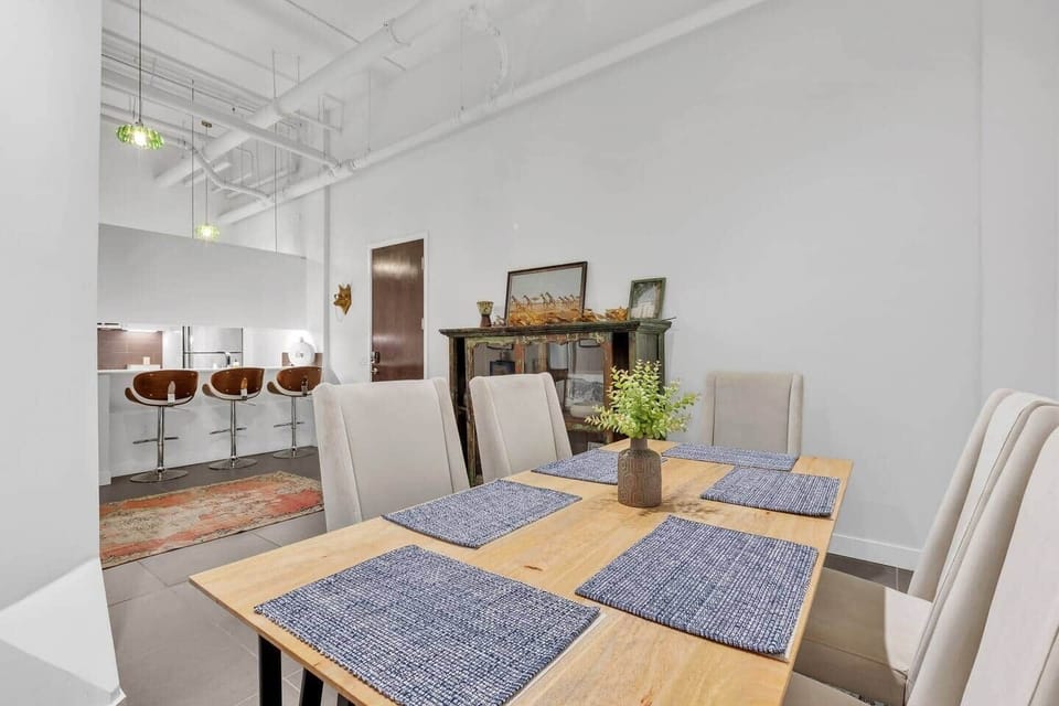 Spacious dining area with a stylish table, comfy chairs, and plenty of natural light.