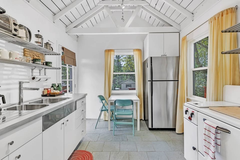 Cook with joy in this sunlit kitchen, featuring modern appliances and a warm, inviting ambiance.