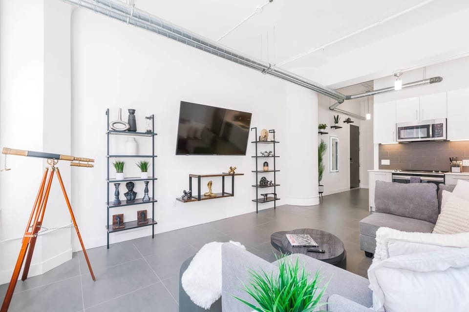 Bright and cozy living space with comfy seating and a high-definition TV for relaxing.