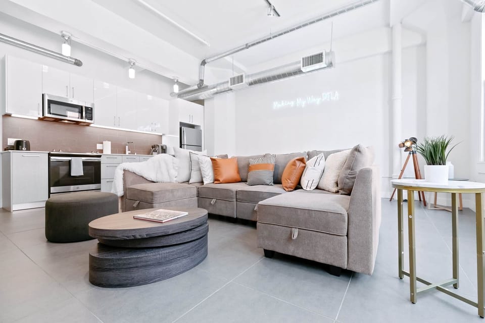 Experience our open living space, filled with natural light, cozy seating, and a TV.