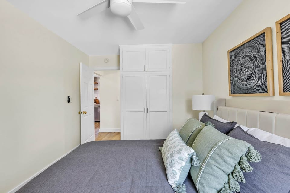 Unwind in our elegantly designed bedroom with a cozy queen bed, calming colors, and a peaceful vibe.