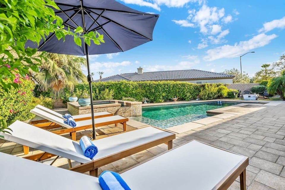 Resort-style poolside area, perfect for relaxing in the shade.