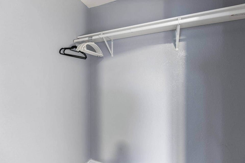 Generous closet space with hangers and shelving makes it easy to stay organized and feel at home.