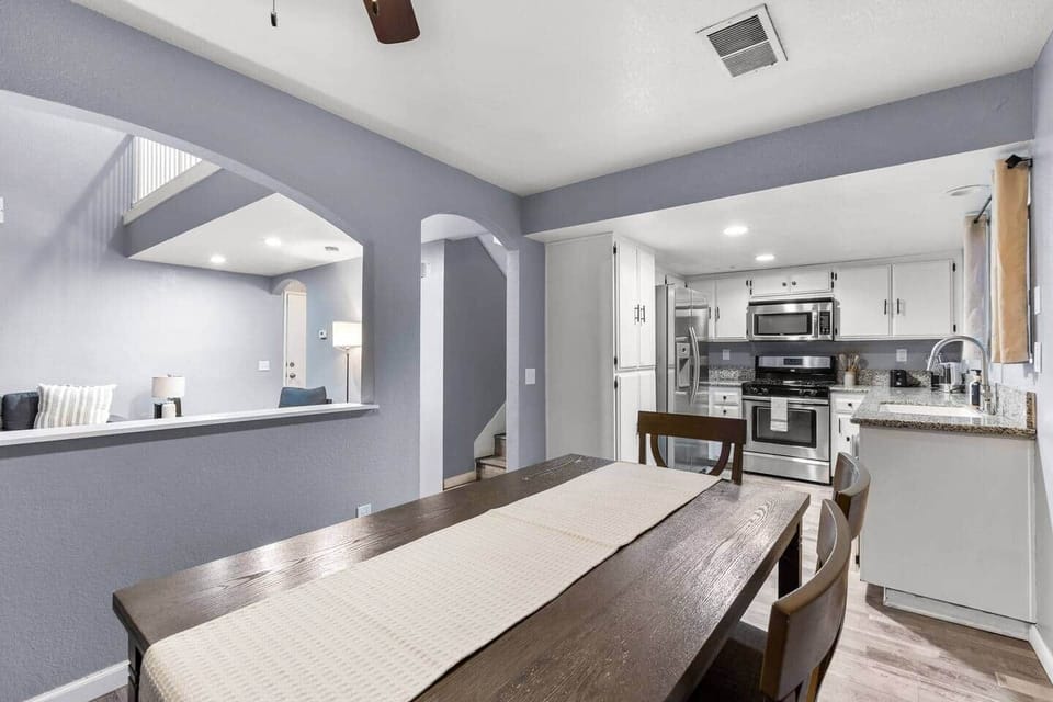 Gather for meals at the farmhouse-style table, with easy flow between the kitchen and living areas.