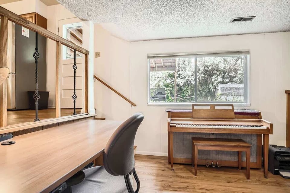 A convenient desk in the living room faces the kitchen, providing a bright and functional workspace while staying connected to the main living area.