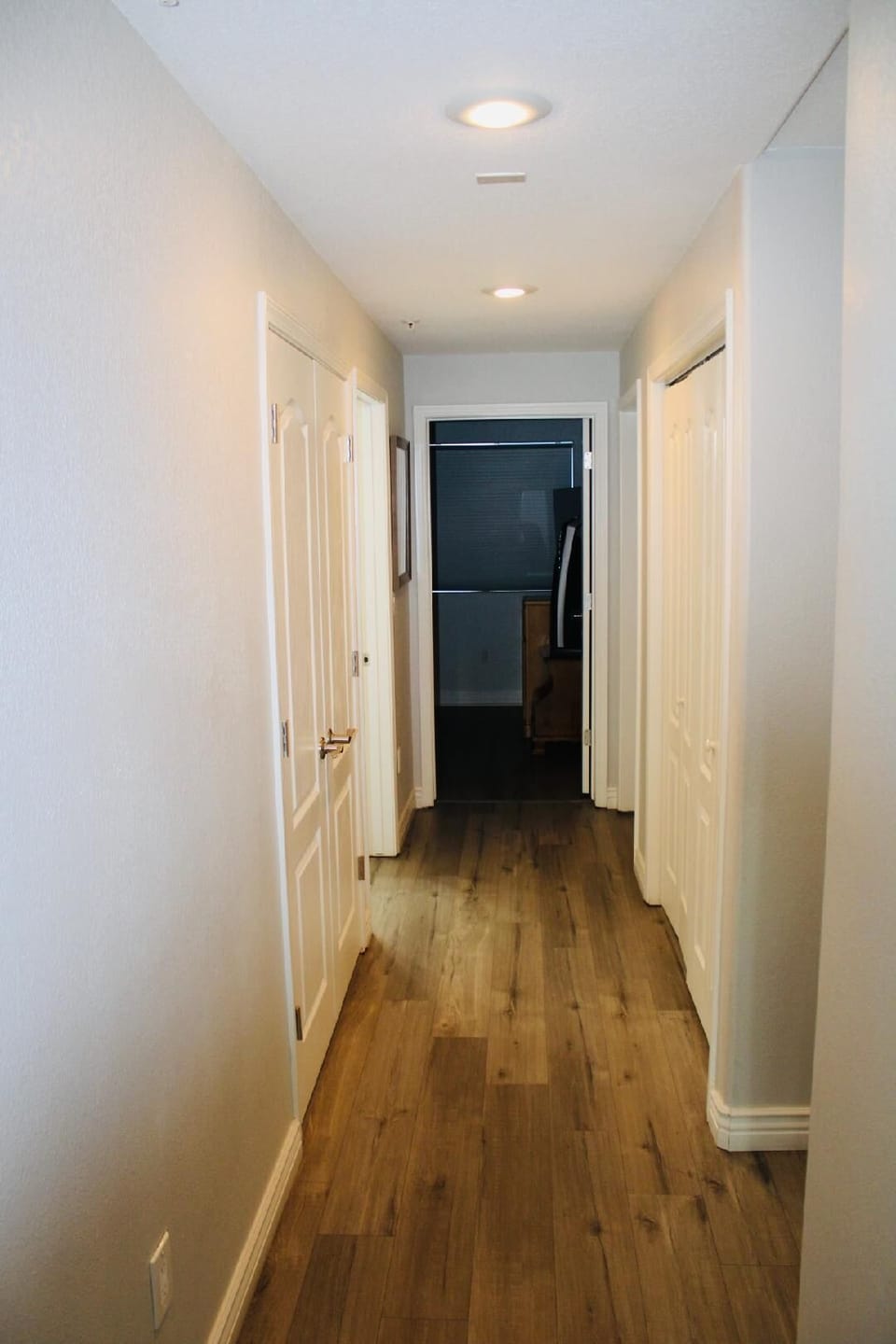 Hallway to bedrooms, hallway bathroom, and laundry closet