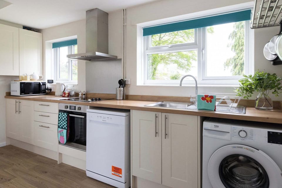 Stunning kitchen features beautiful cabinets and sleek appliances that make cooking a joy.