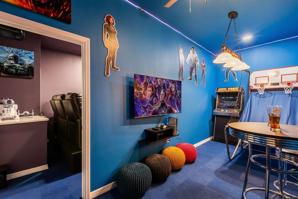 Game Room with Arcade Fun – Basketball hoops, arcade games, and wall art for all ages.