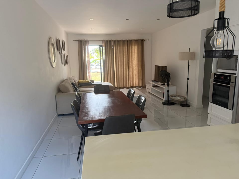 dining and living room space. TV and wifi. sliding door leads to outdoor terrace