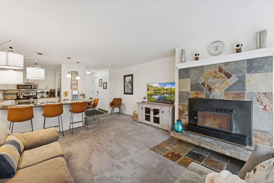 Perfect spot to unwind, spacious seating, fireplace, and open kitchen.