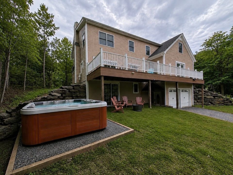 Private hot tub + fire pit — the perfect Vermont après-ski setup.