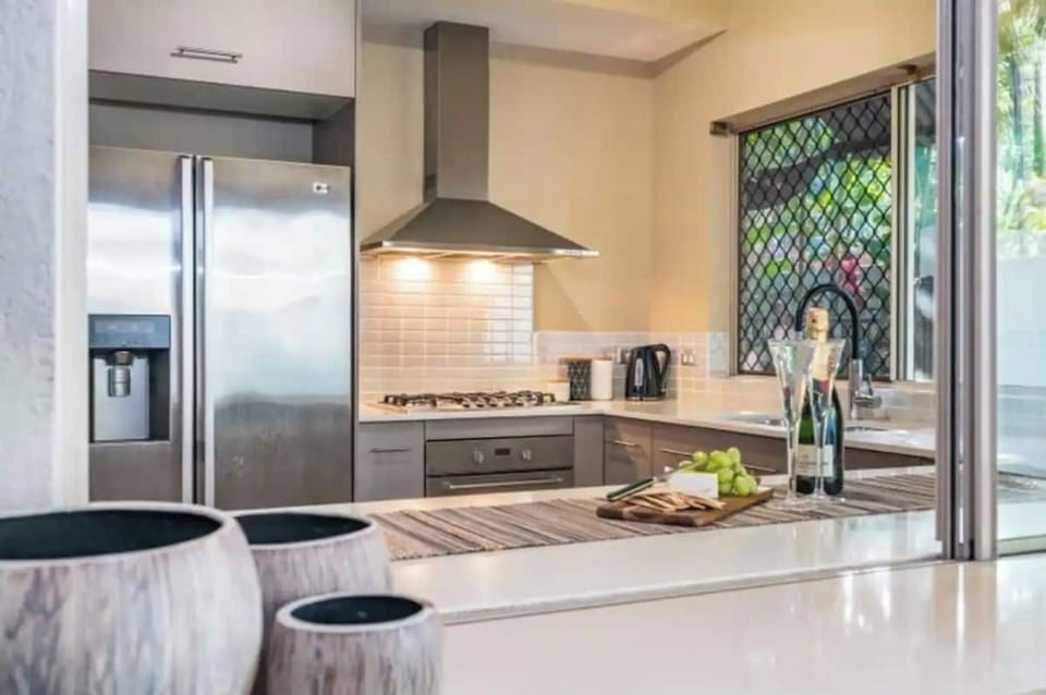 Kitchen | Cairns One | Fully equiped kitchen with servery window onto the pool area patio.
