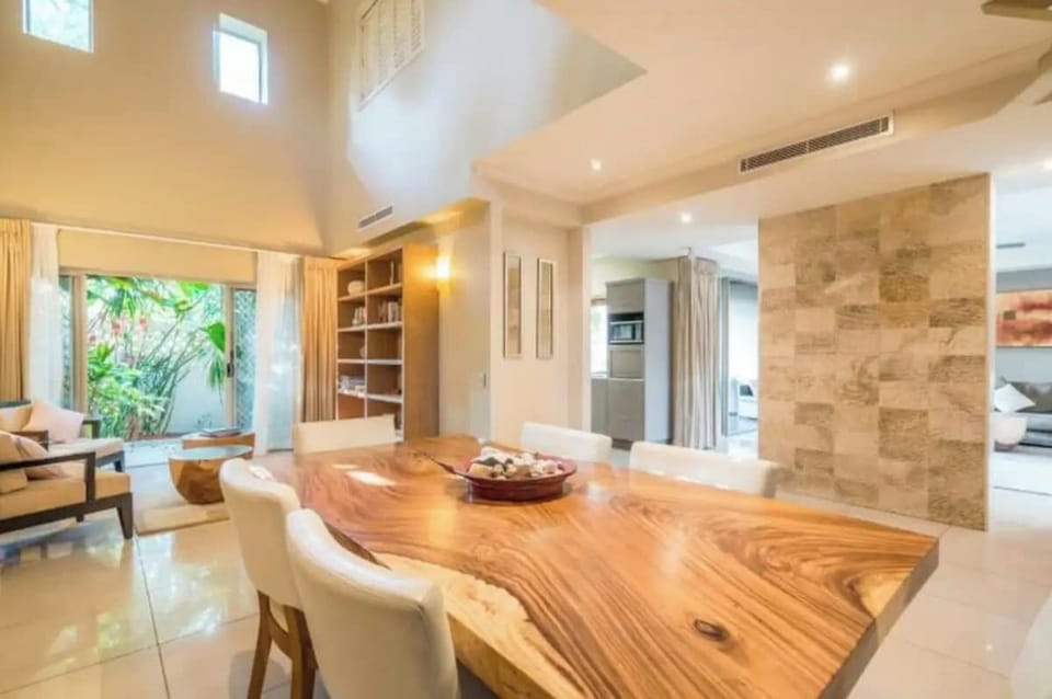 Dining Area | Cairns One | This open plan space features high ceilings and access onto a courtyard.