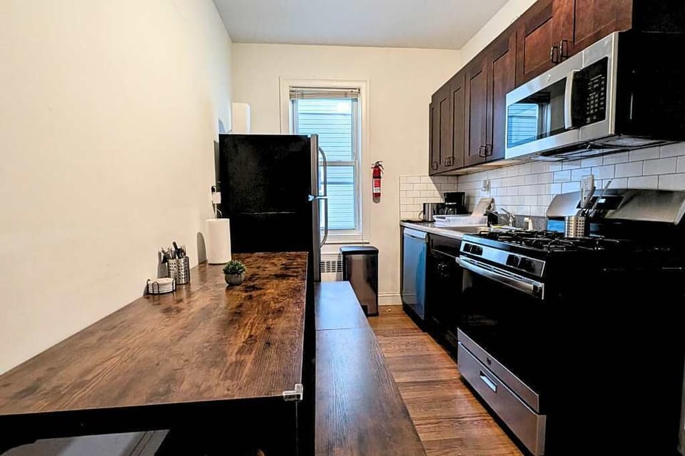 Cook with ease in a fully equipped kitchen featuring modern appliances, spacious counters, and quick access to Newark Penn Station.