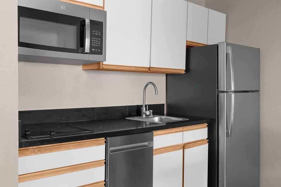 Cook and snack easily with fridge, microwave, and sink.