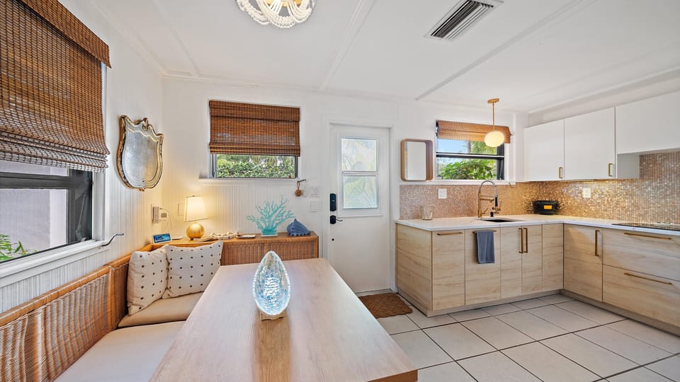 Bright kitchen nook with coastal touches and seating for family meals and socializing.
