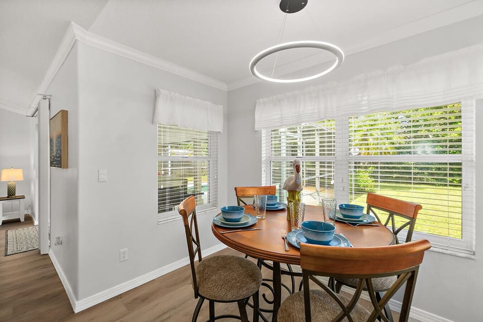 Charming breakfast nook with large windows overlooking the backyard, creating a bright and relaxing space to enjoy meals.