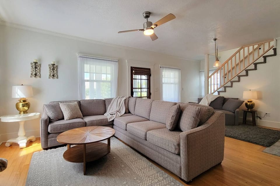 Open living room with comfy couch and new SMART TV