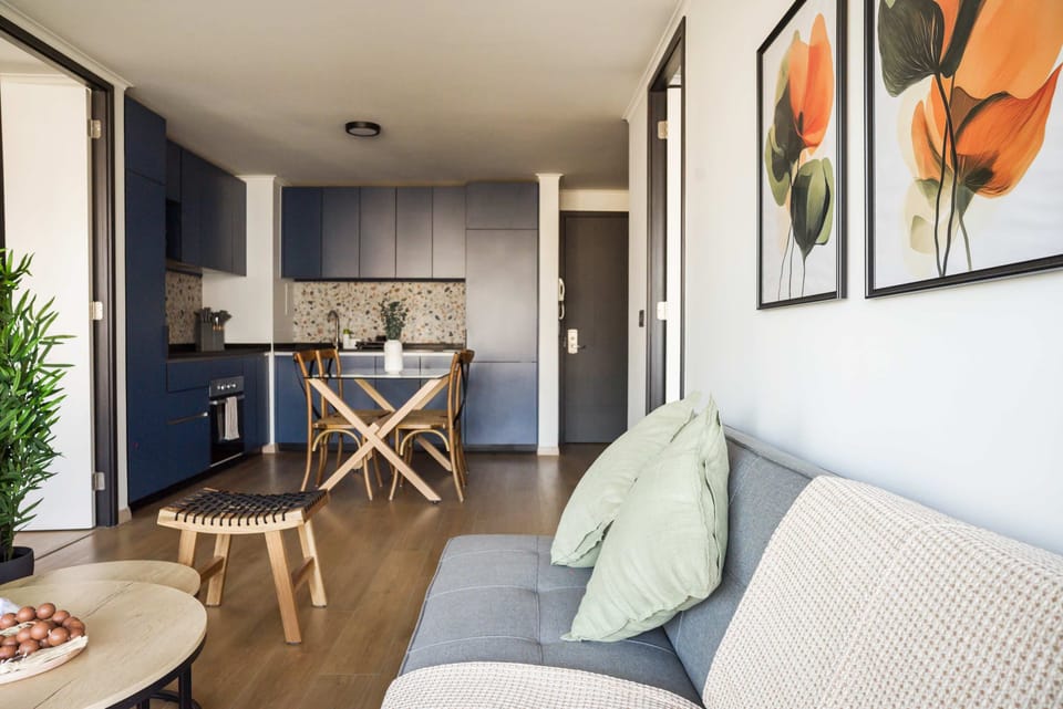 Stylish living area with a modern kitchen and vibrant decor, perfect for relaxation and dining.