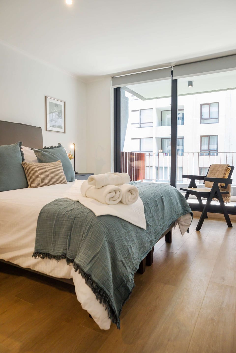 Relax in this cozy bedroom with a private balcony, perfect for unwinding after exploring the city.