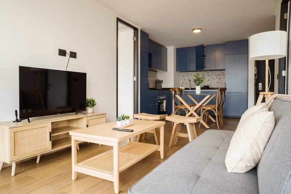 Modern living area with cozy seating and stylish kitchen, perfect for relaxation and dining.