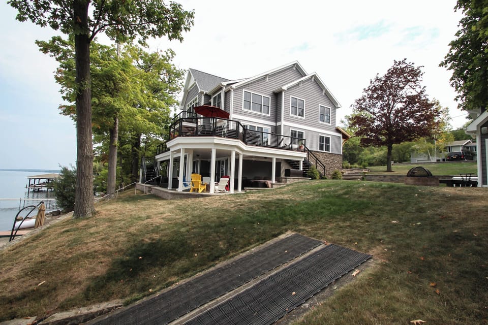 Enjoy the perfect lakefront retreat in this stunning multi-level home, featuring expansive decks, modern design, and direct access to the water.