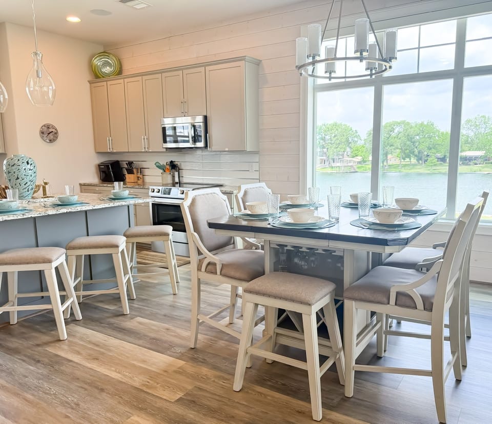 Dining table with seating for 6 and additional seating at kitchen island.